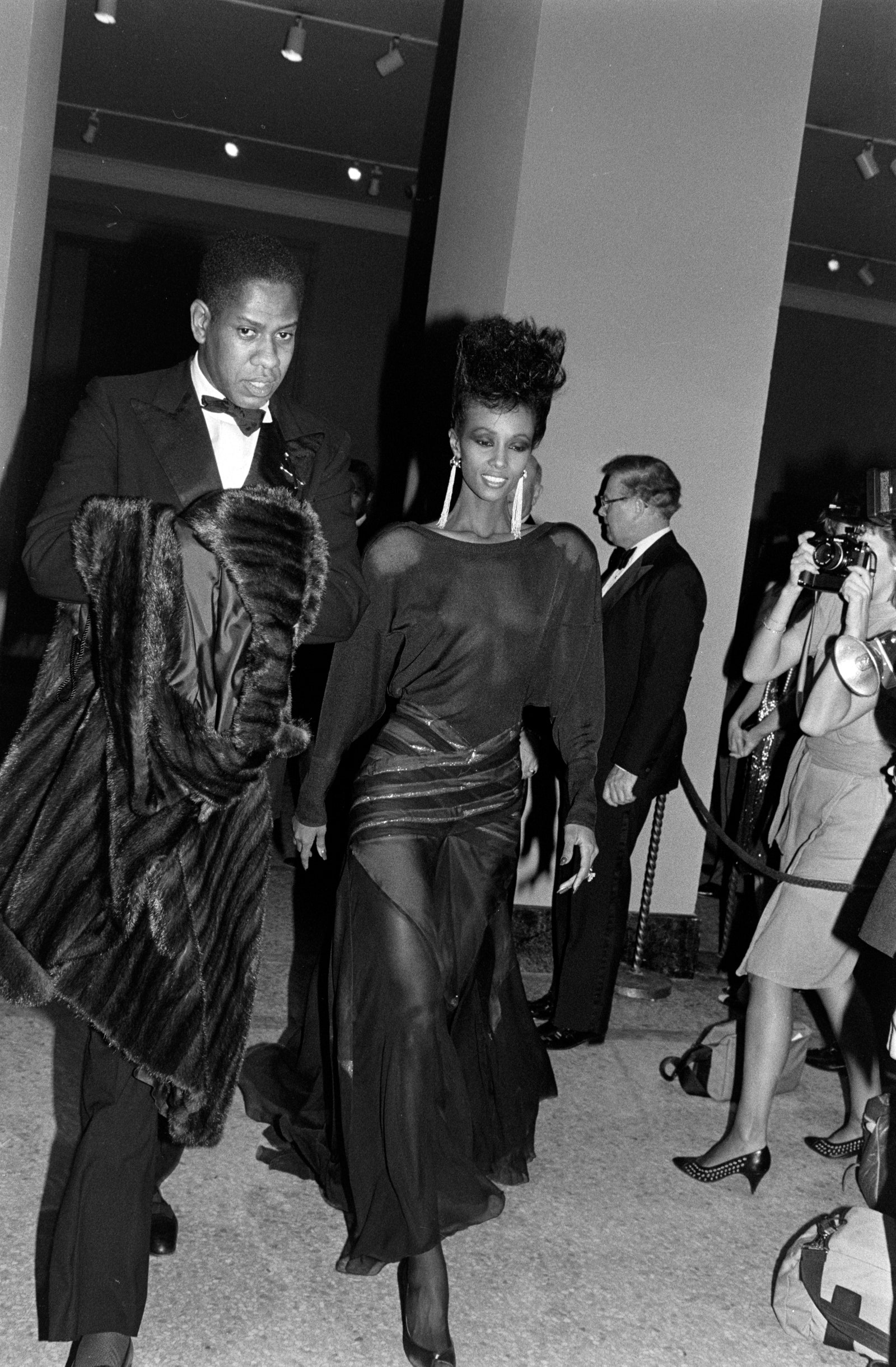 Images may contain Andr Leon Talley Iman clothing formally wearing suit adult fashion accessories and bags