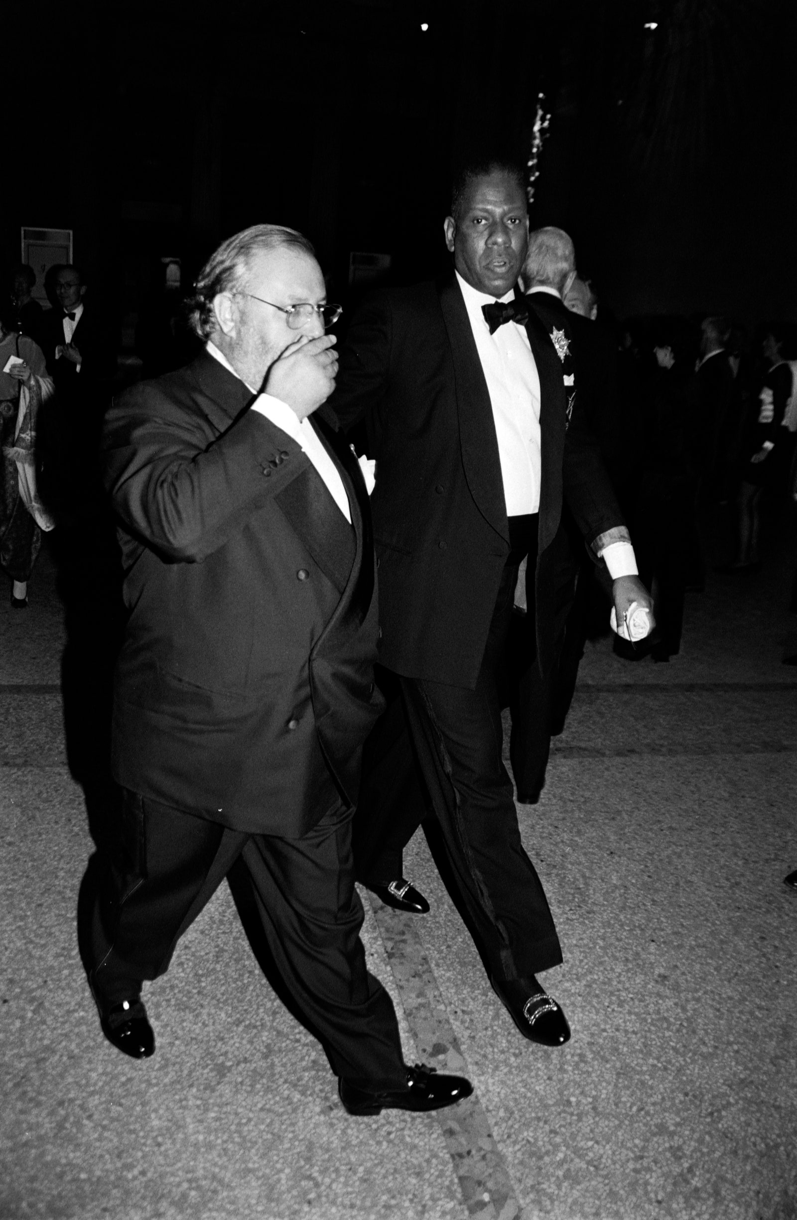 Images may contain Gianfranco Ferr Andr Leon Talley outfit, formally in suit tuxedo and walking