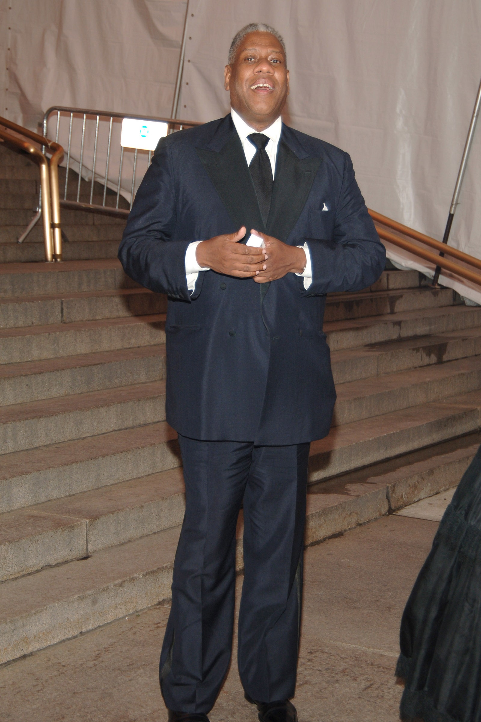 Images may contain Andr Leon Talley blazer formally wearing suit staff standing and building