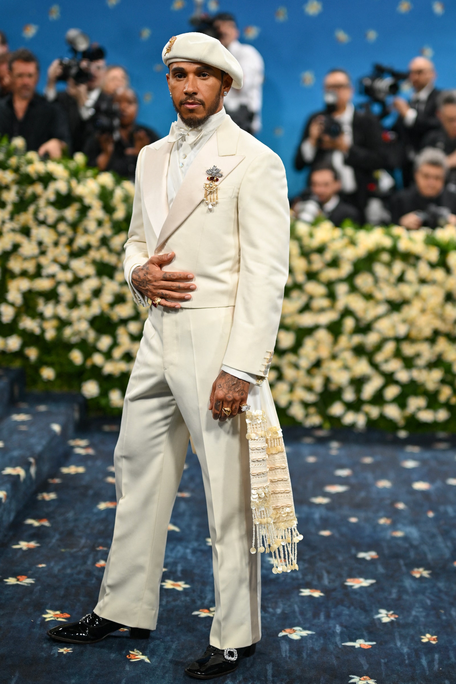 Images may contain Lewis Hamilton Villaño III clothing hat adult shoes shoes accessories jewelry and rings