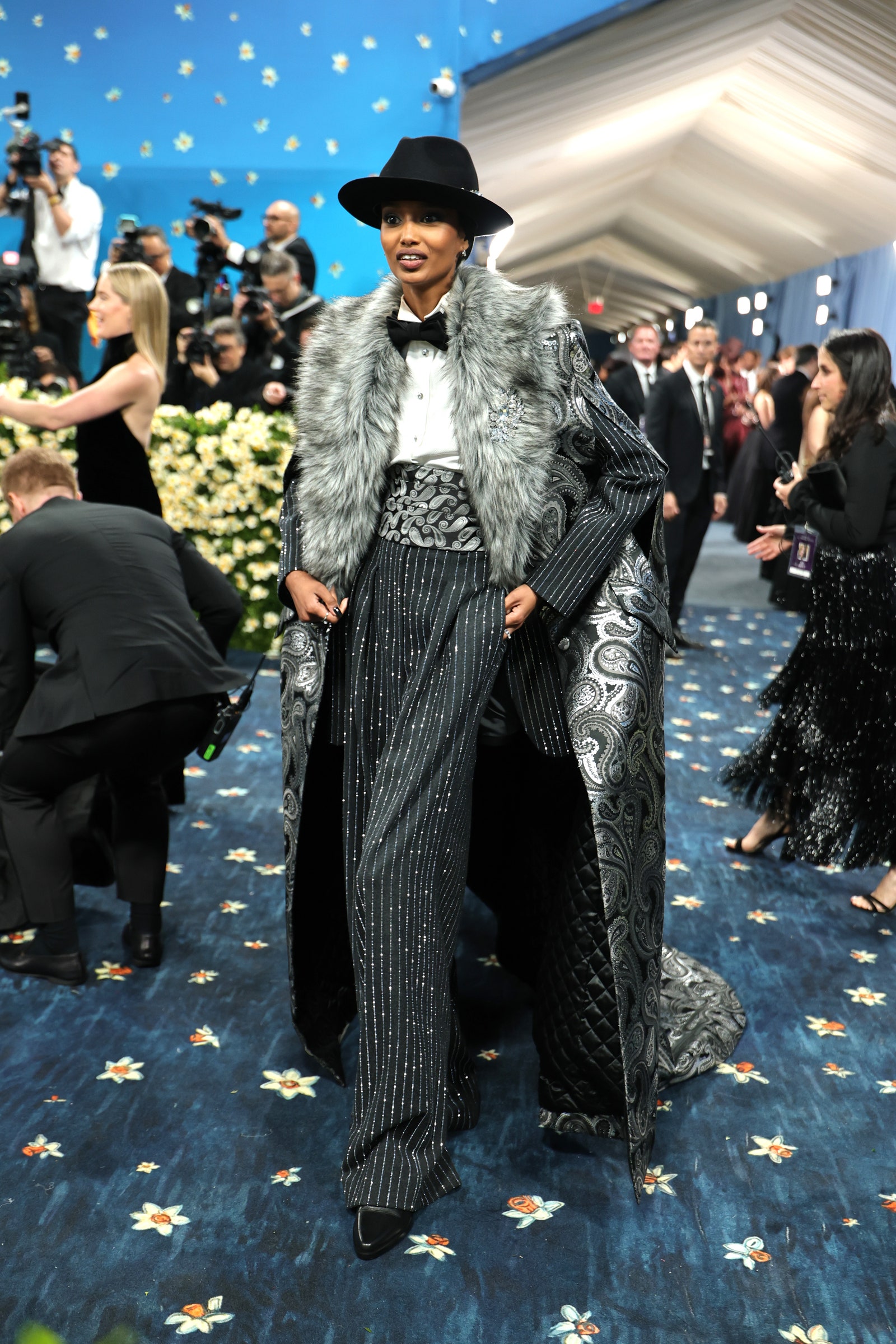 Images may contain Fatima Siad clothing formally wearing suit hat adult accessories tie shoes and shoes