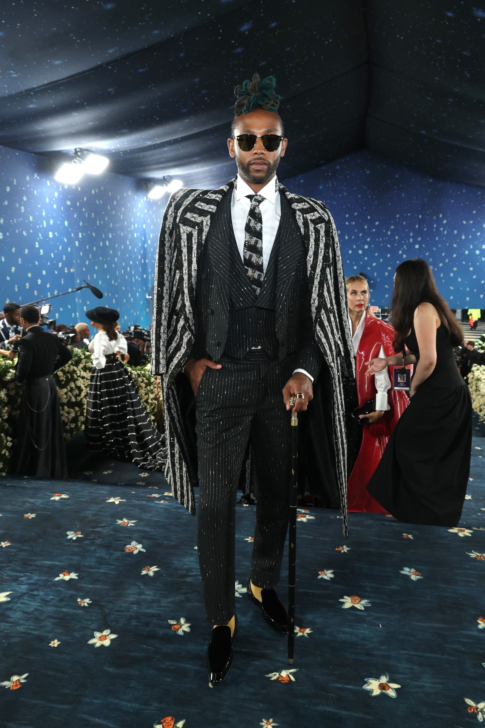 Images may contain adult accessories glasses, formal wear belt hood shoes and stylish