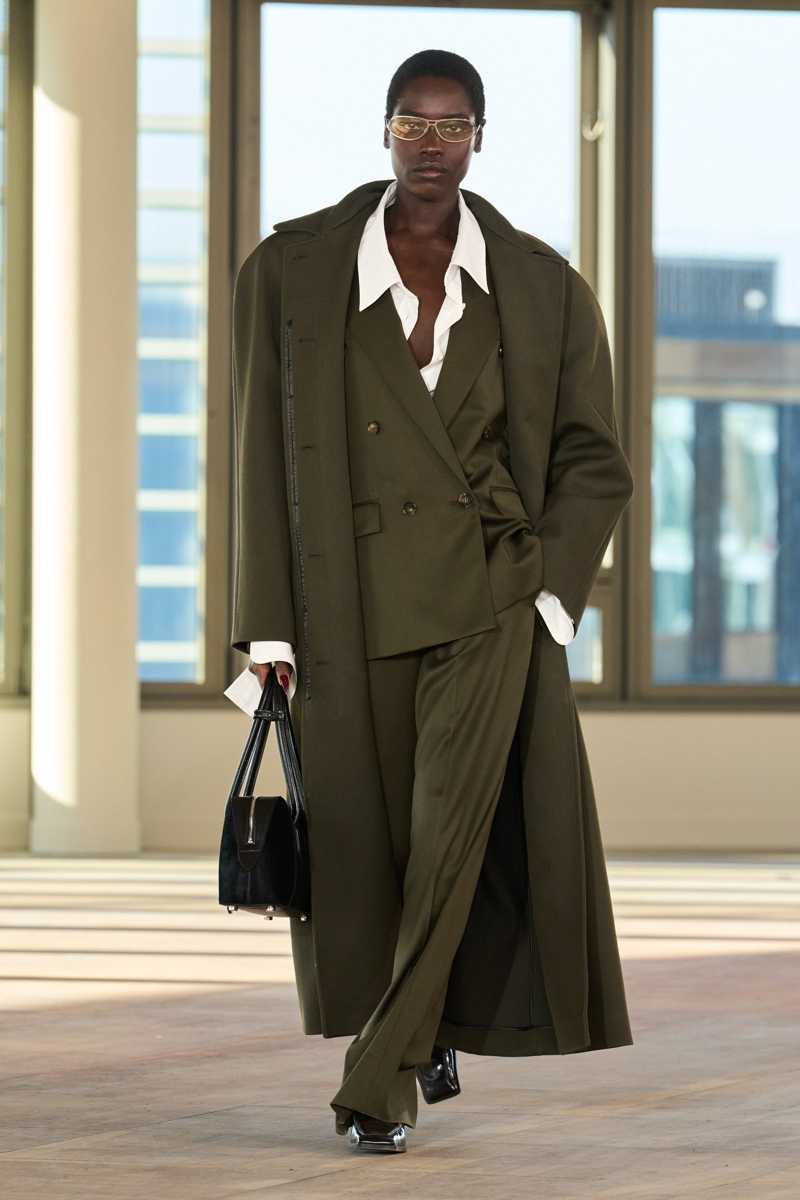 Images may contain clothing jacket accessories glass bag handbag jacket footwear and shoes