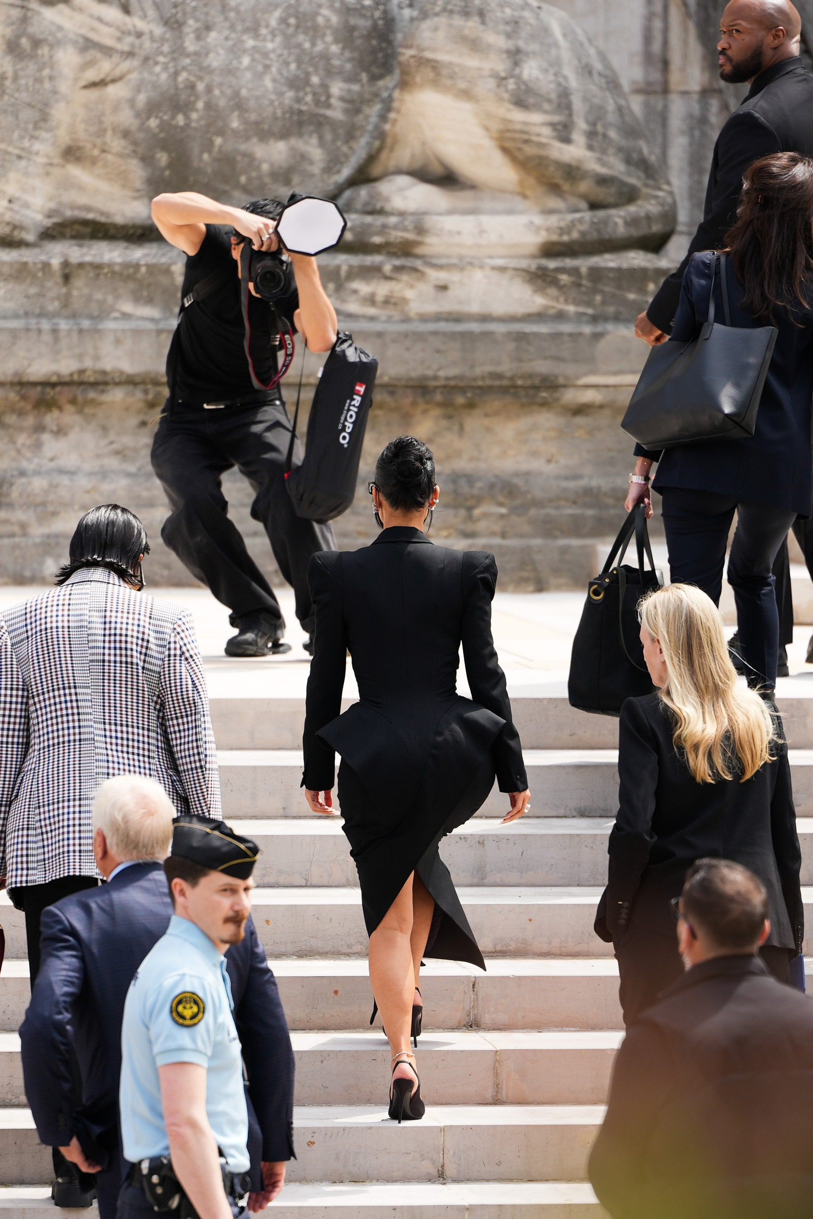 Images may contain accessories bags tote bags clothing shoes high heels adult hat glasses and camera