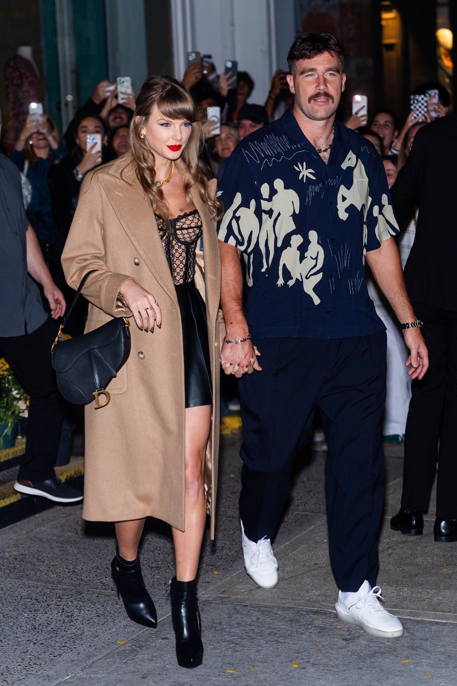 Images may contain Travis Kelce Taylor Swift Dola Banerjee Gale Brewer Clothing Shoe Lace Accessories and Bags