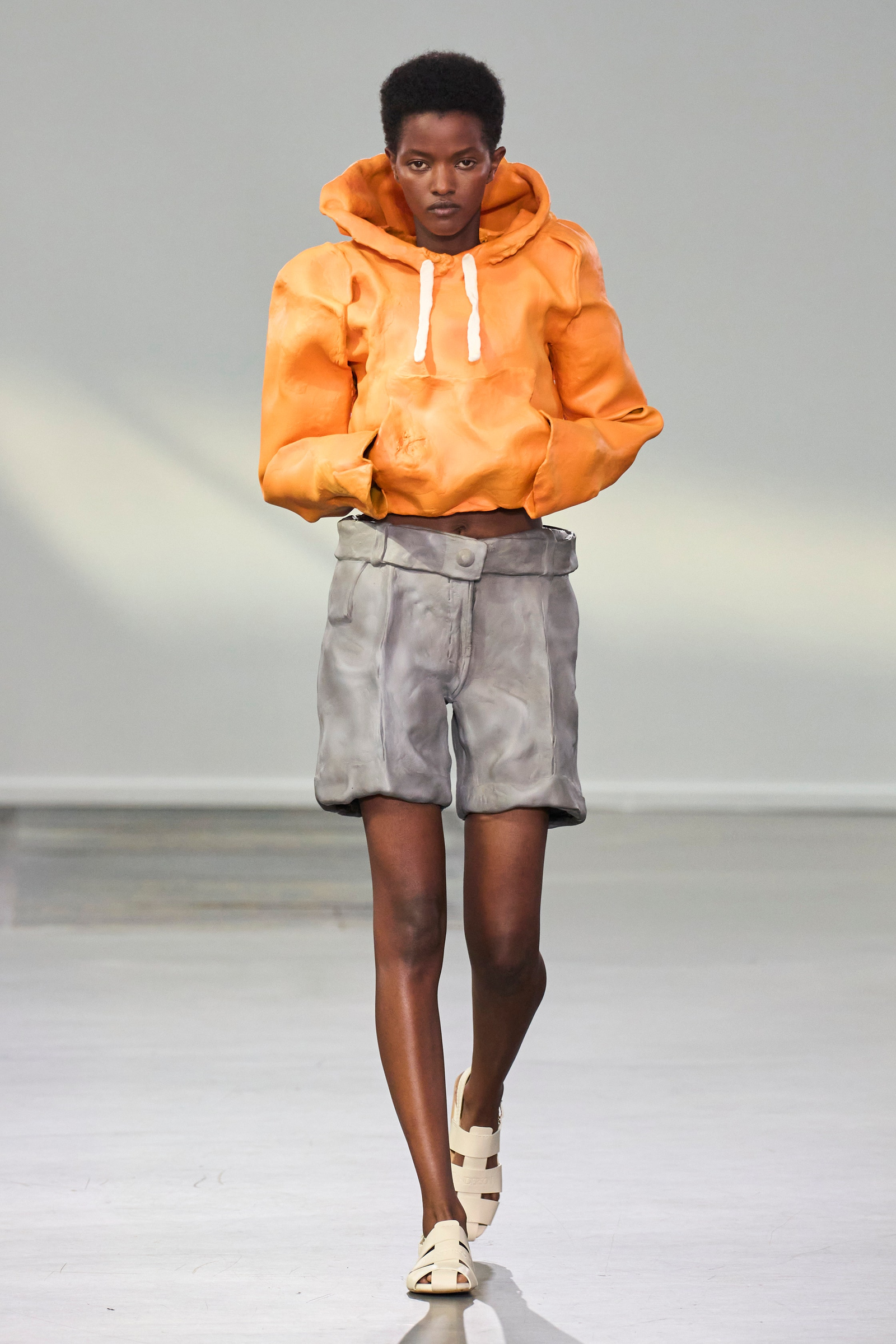 Images may contain Cassandra Freeman Clothing Blazer Shorts Sandals Adult Hoodie and Sweater