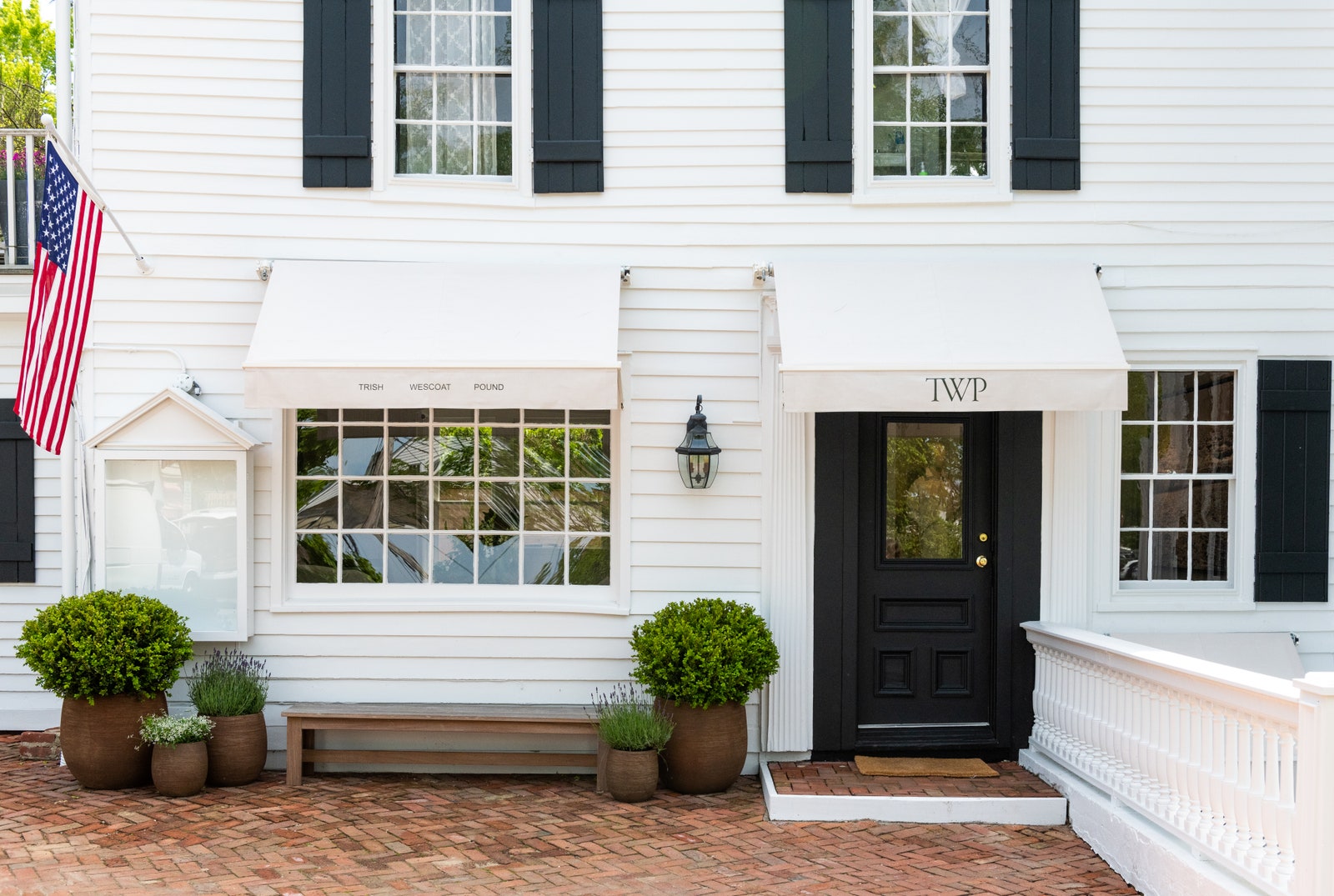 Images may contain flags, plant lights, benches, furniture, buildings, houses and porches