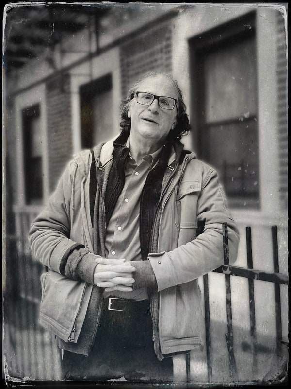 Image may contain Clothing Coat Photography Jacket Face Head Person Portrait Body Part Finger Hand and Adult