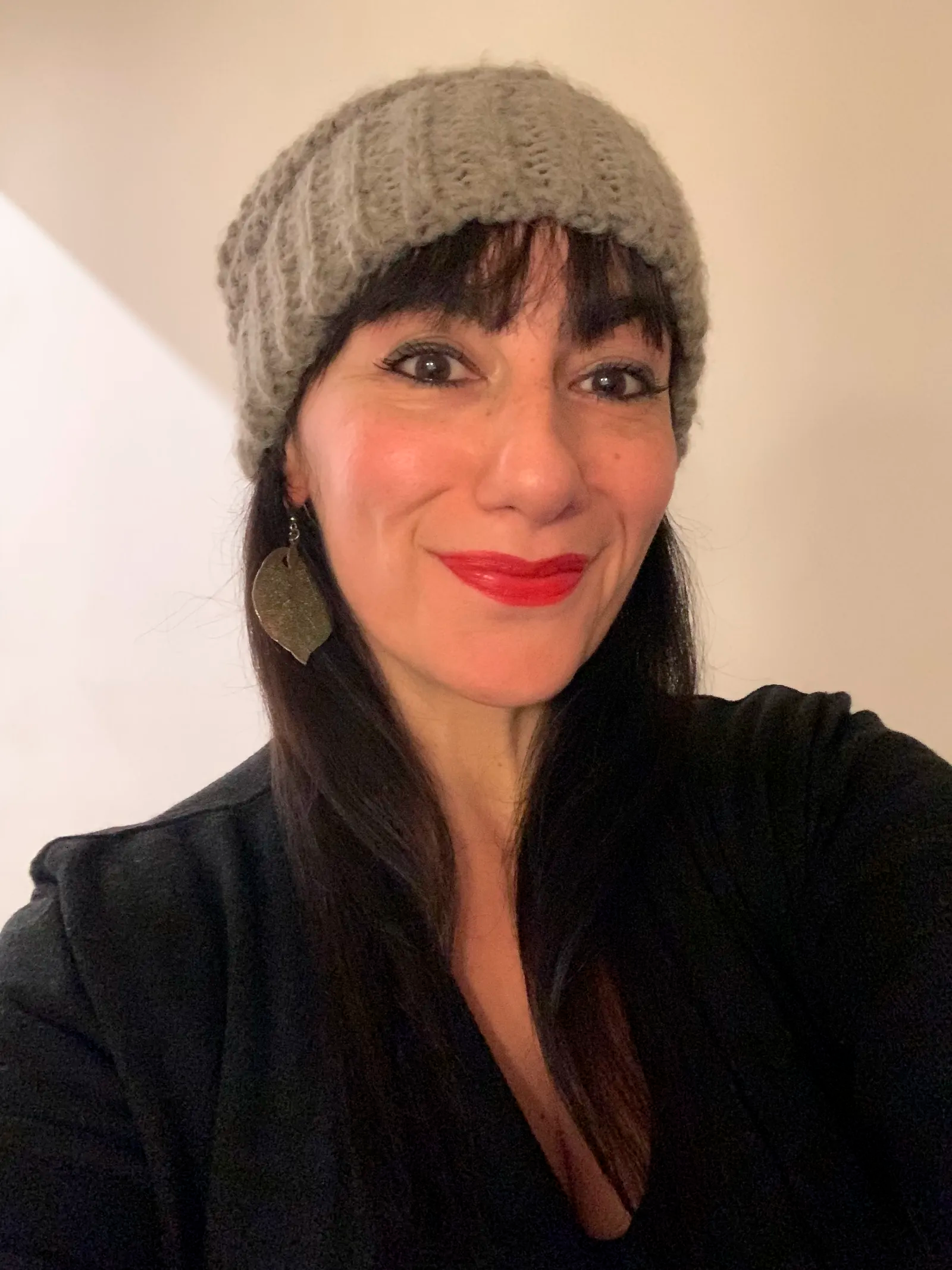 Image may contain Cap Clothing Hat Adult Person Face Head Happy Smile Cosmetics and Lipstick