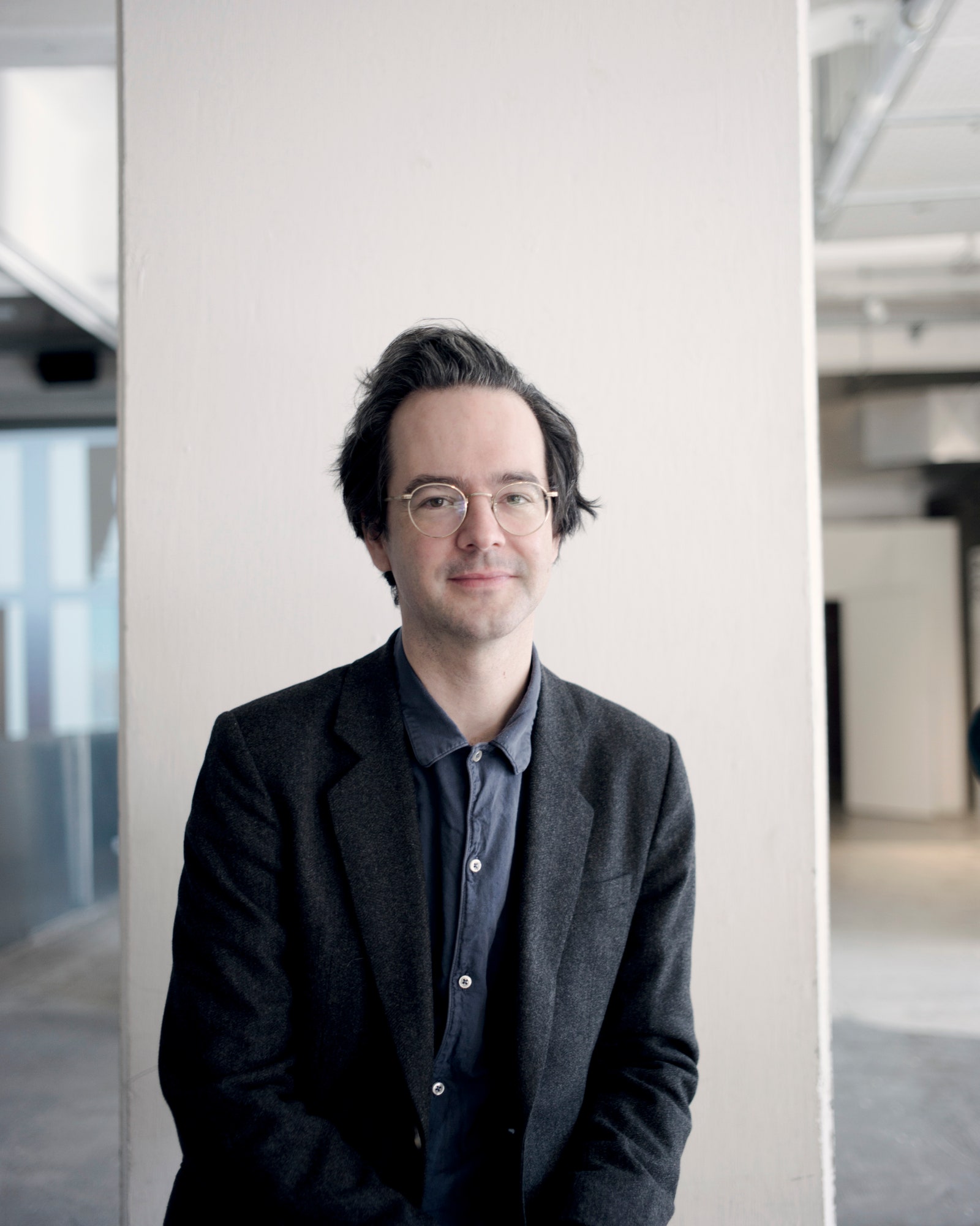 Image may contain Blazer Clothing Coat Jacket Face Head Person Photography Portrait Happy Smile and Adult
