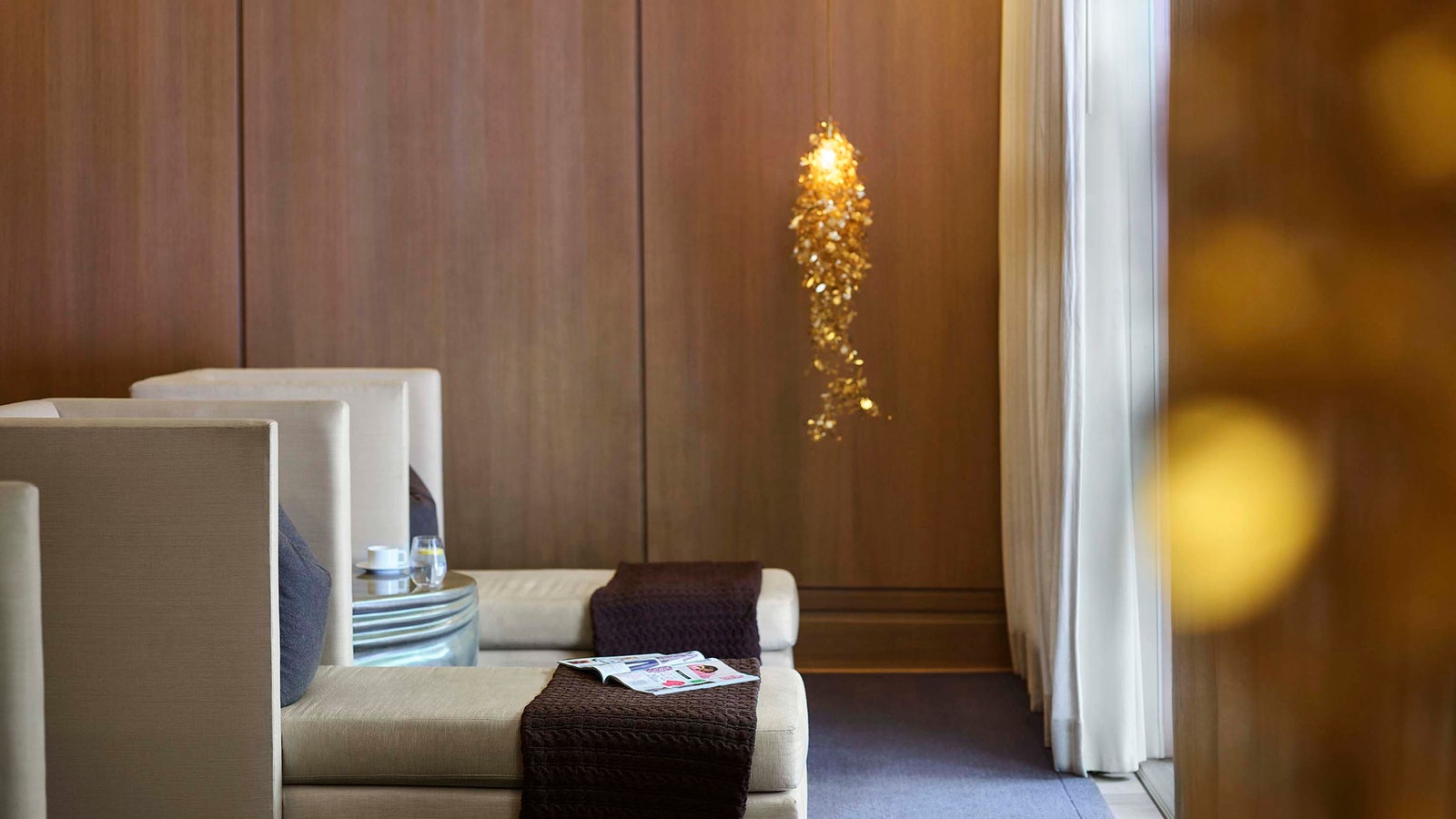 Images may contain interior design book publications wood panel sofa furniture chandeliers and lighting