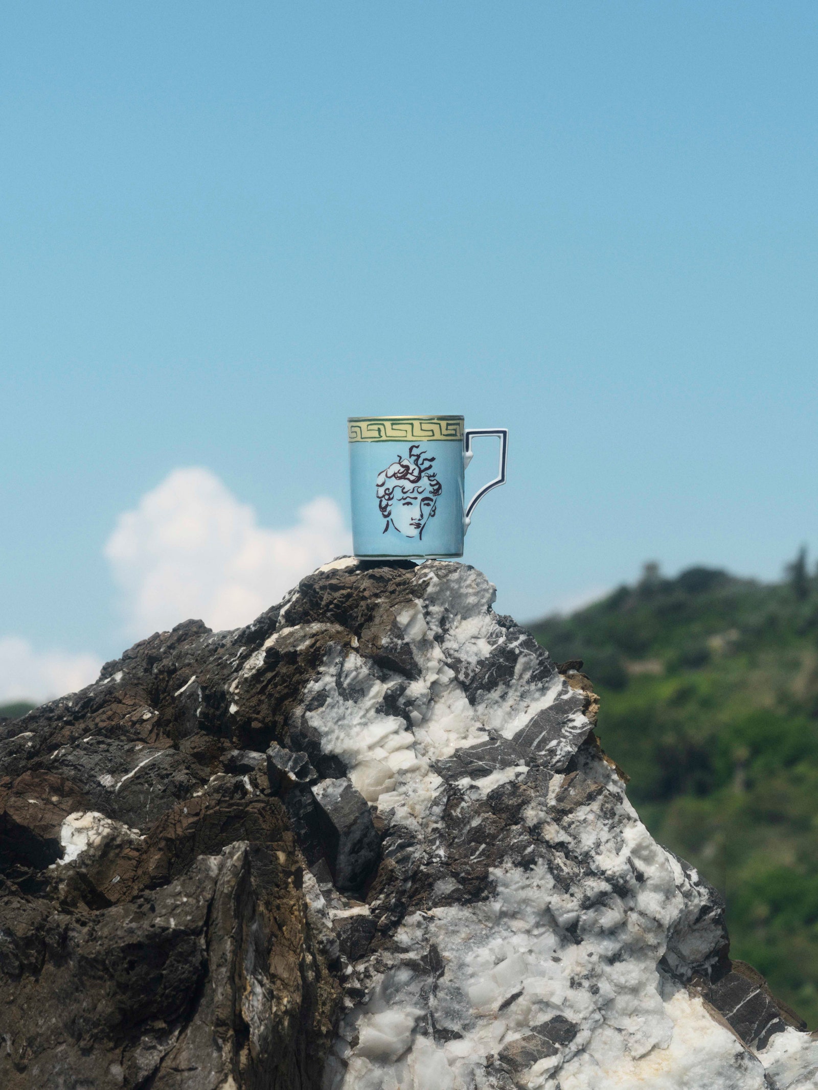Images may contain rock cliffs natural outdoor cup mountain peak sky and landscape