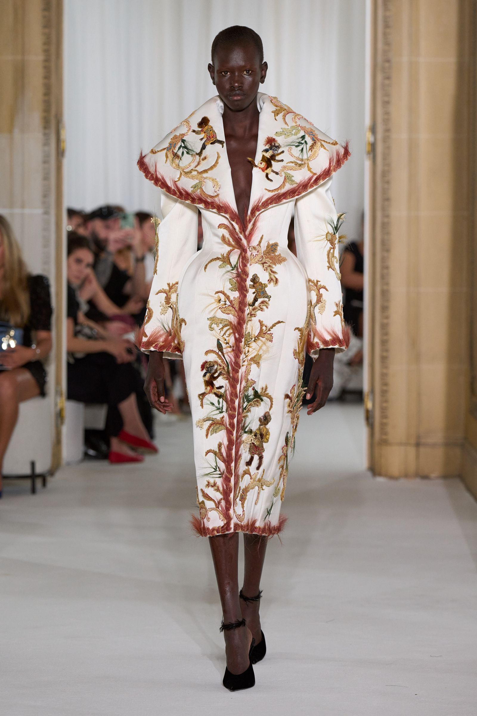 Images may contain Alek Wek Tahmasp I adult clothing jacket high heels and fashion