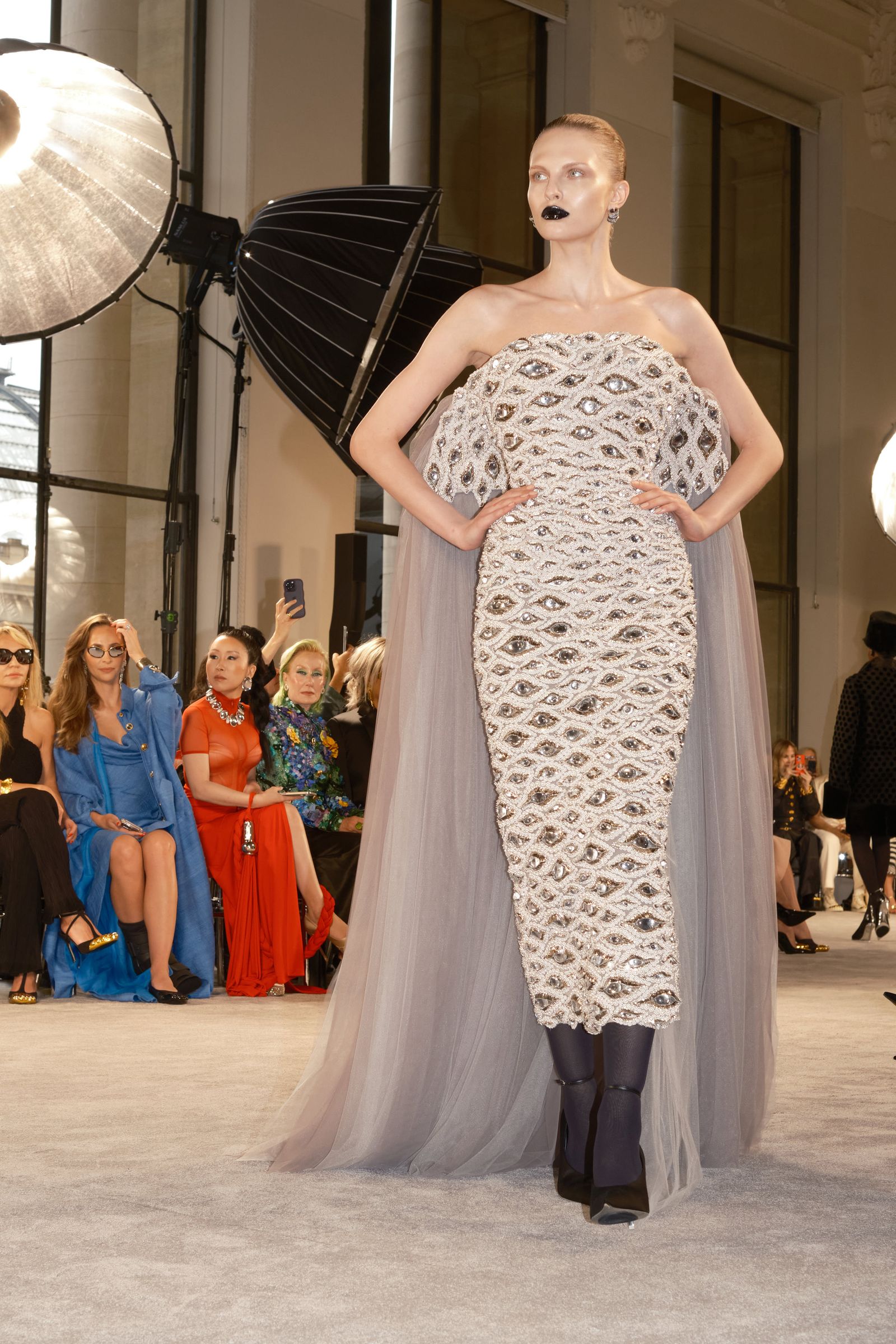 Images may contain Ivana Wong Caroline Cellier clothing gown evening dress, formally wearing electronic devices and cell phone