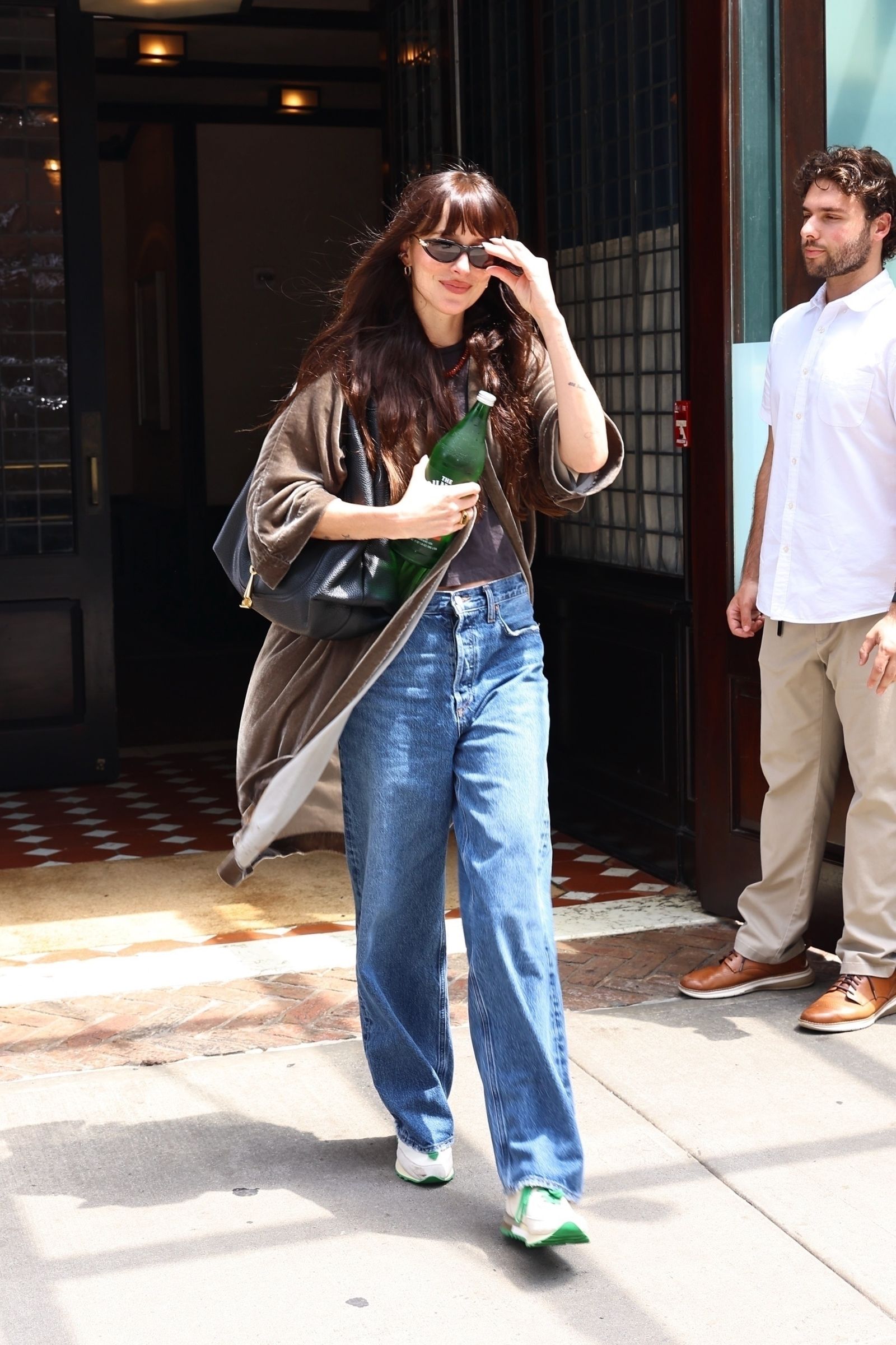 Images may contain Dakota Johnson clothing pants jeans shoes shoes teen accessories bags and handbags