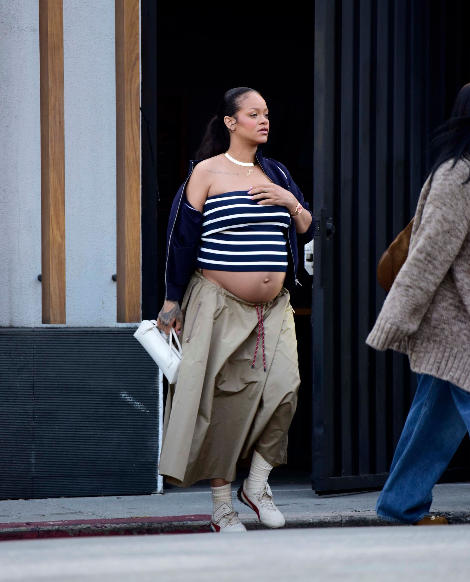 Images may contain Rihanna pedestrian clothing shoes and shoes adult accessories handbags and jewelry