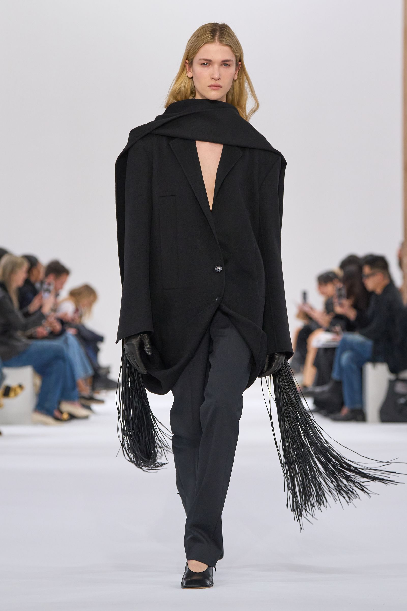 Images may contain stylish clothing gloves cape jacket accessories bags tote bag adult footwear and shoes