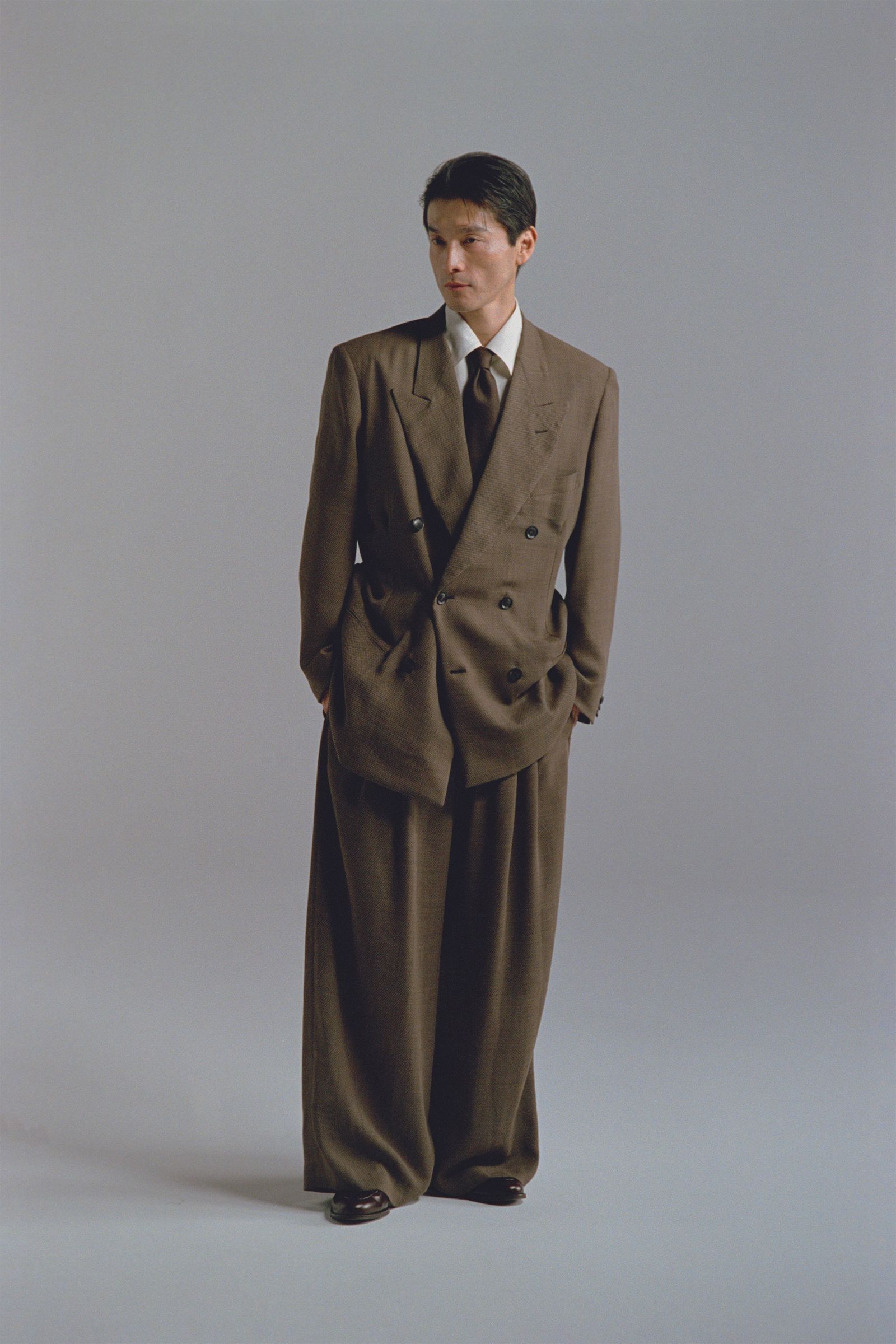Images may contain clothing formal clothing jacket accessories tie adult tuxedo jacket and jacket