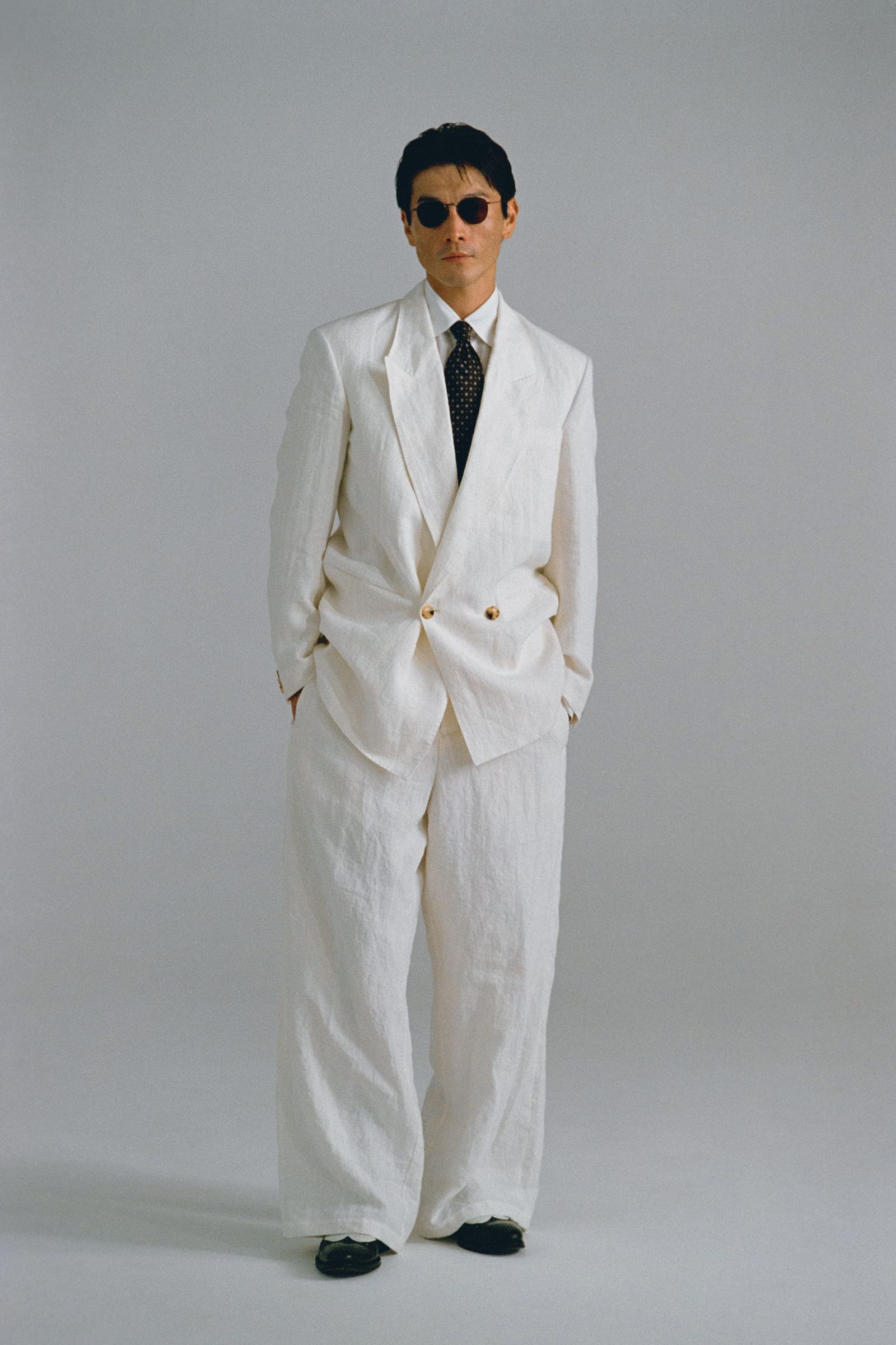 Images may contain clothing formal wear suit tuxedo jacket home decor linen accessories tie and adult