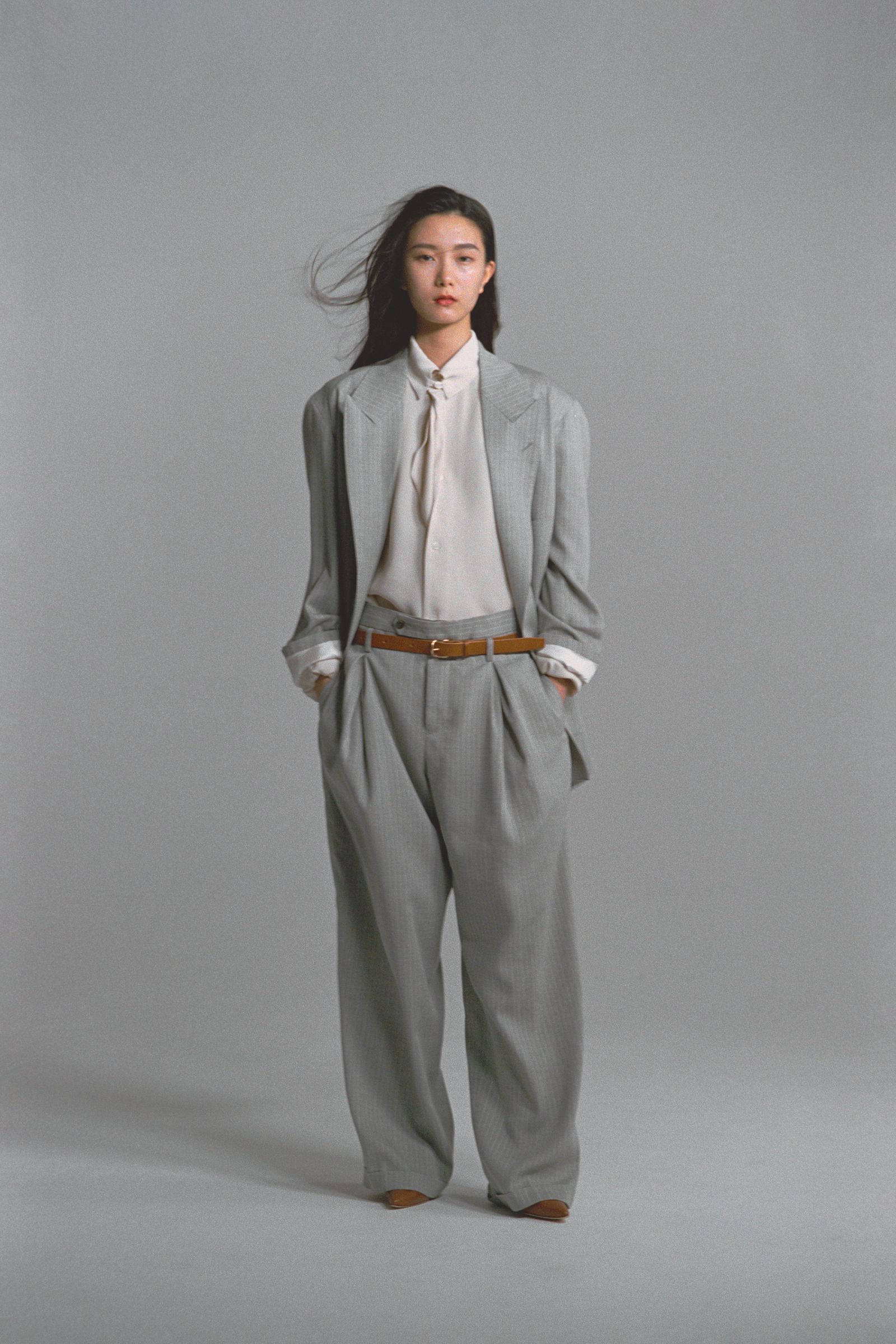 Images may contain clothing formal suit staff accessories, tying pants, jacket, home decoration and linen